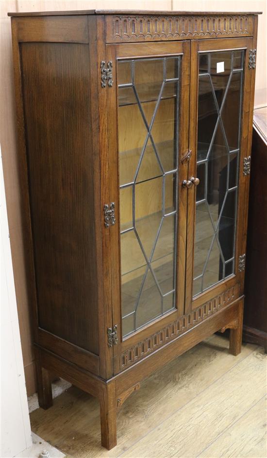 A carved oak two door leaded cabinet W.81cm